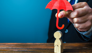 Insurance agent holds an umbrella over a men with a crack. Rehabilitation after trauma, drugs, alcohol. Health and life insurance. Psychological help. Social support. Recovery. Protectorate, patronage